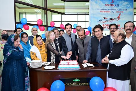 Kundi cuts the cake during the inaugural ceremony marking the launch of South Air’s flight service from Peshawar to Quetta at Bacha Khan International Airport, Peshawar.